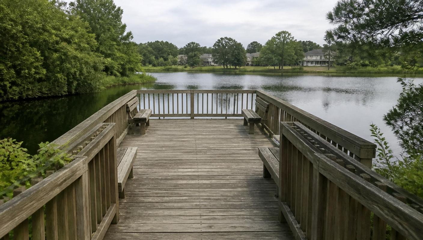 Wooden observation dock and benches over a quiet Reston lake, similar to the Lake Thoreau dock