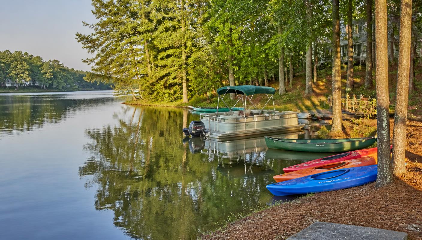 Kayaks and a pontoon boat with an electric motor moored on a Reston Association lake
